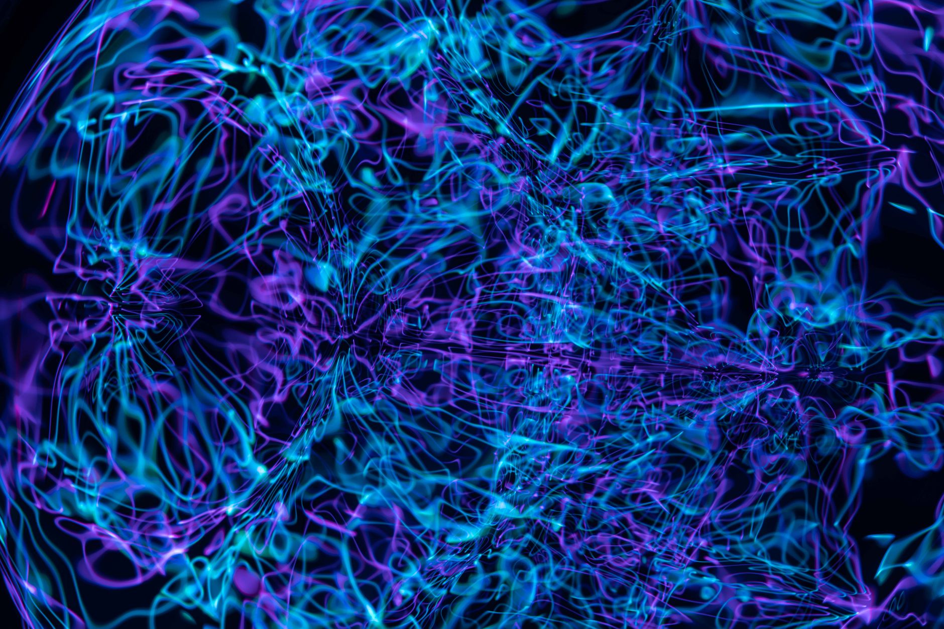 Violet and blue plasma filaments glowing on a dark background, evoking high-frequency energy